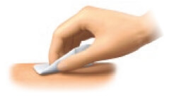 Image of hand wiping injection site on the body with an alcohol pad