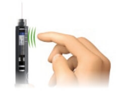 Image of injector pen with needle pointing upward and a finger gently tapping the cartridge to let air bubbles rise to the top