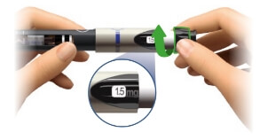 Image of injector pen with dosing window and hands turning the knob to the intended dose. In this case, the window is showing 1.5 mg